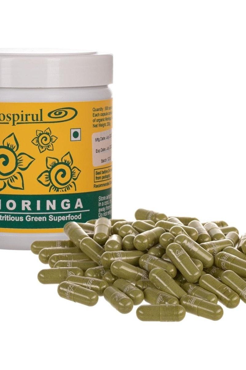 Aurospirul Moringa capsules in a container, showcasing a green superfood rich in nutrients and antioxidants.