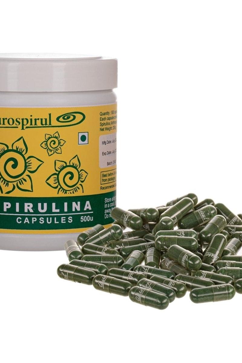 Aurospirul Spirulina capsules in a container with loose capsules, rich in nutrients and antioxidants.