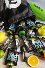 BioTechUSA Energy Gel products spread out with a black bag and citrus fruits, ideal for intense training energy recovery.