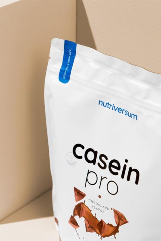 Nutriversum Casein Pro chocolate flavor protein powder package on neutral background.
