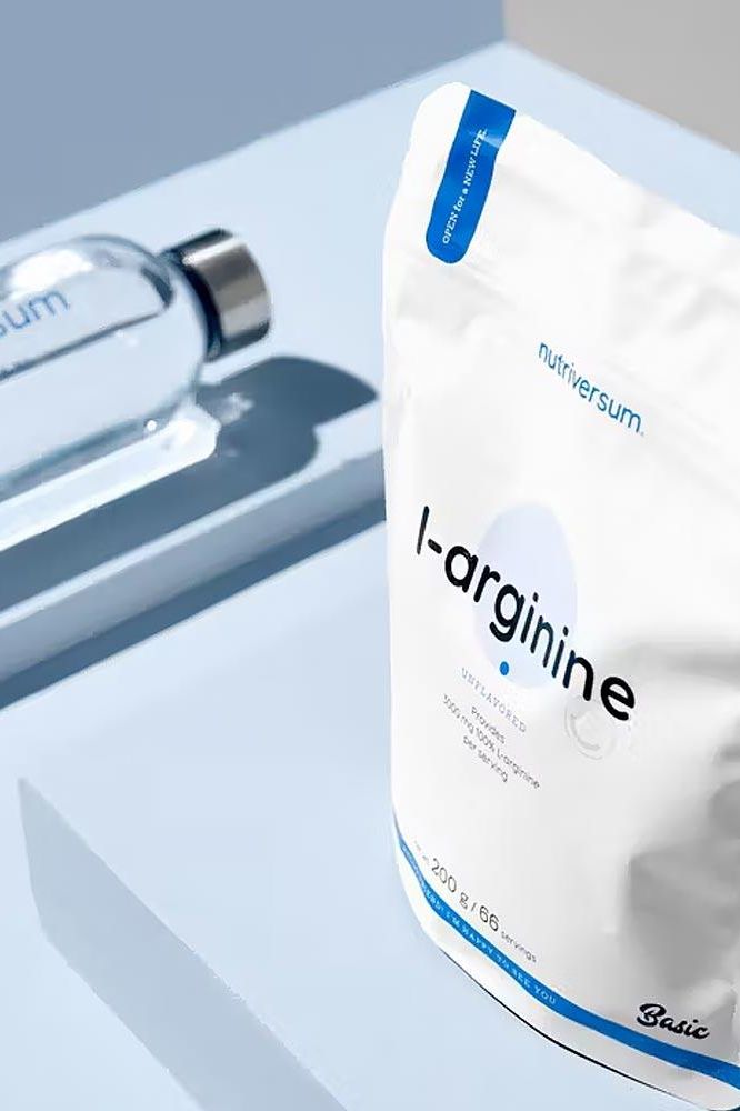 Nutriversum L-Arginine unflavored powder 200g pack displayed with a water bottle on a light blue background.