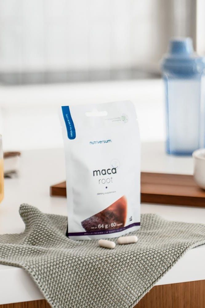 Nutriversum Maca Root 60 capsules on a kitchen counter with a soft cloth and shaker bottle in the background.
