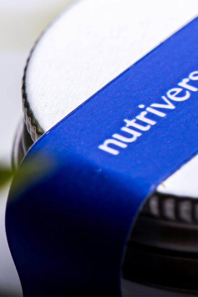 Close-up of Nutriversum product lid showcasing the logo and blue design