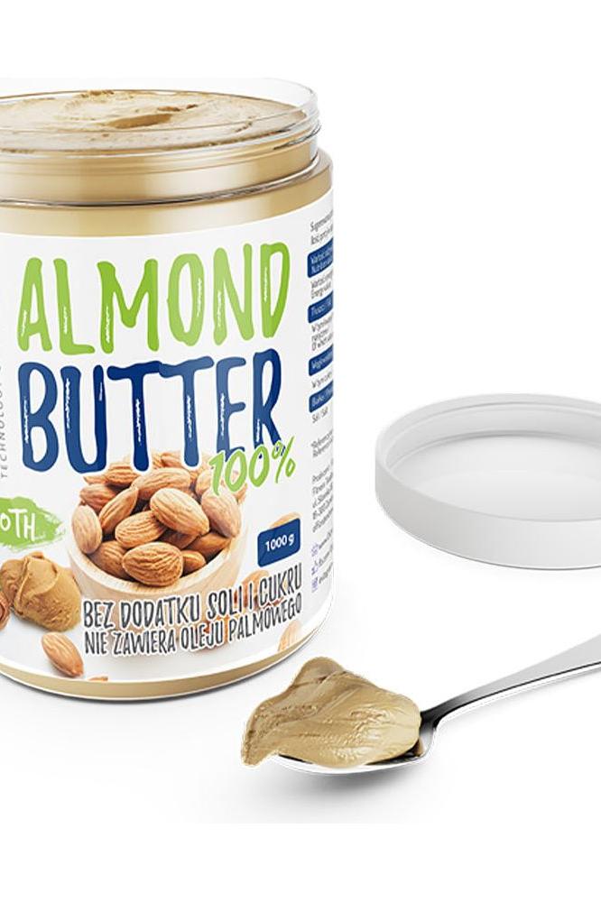 OstroVit Nutvit 100% Almond Butter jar with spoon and almonds, healthy vegan protein source, no added salt or sugar.