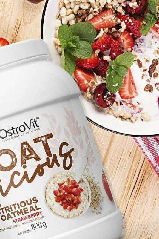 OstroVit OATlicious nutritious oatmeal with strawberries and granola in a bowl, promoting healthy meal options.
