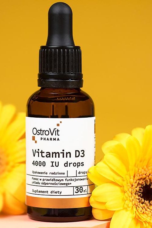 OstroVit Pharma Vitamin D3 4000 IU drops in a dropper bottle with a yellow flower background.