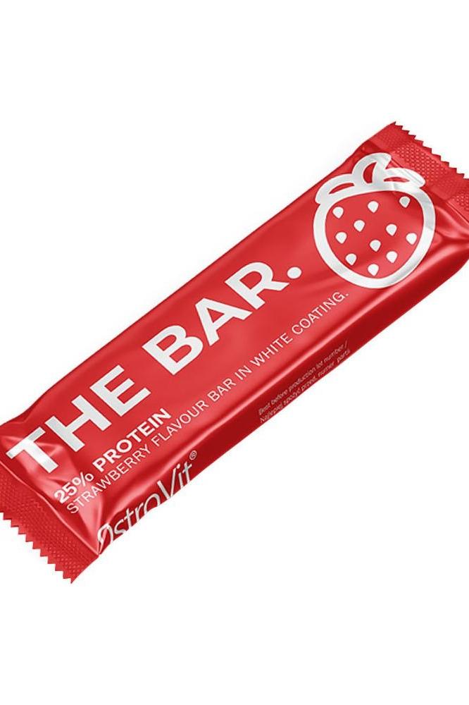 OstroVit THE BAR protein snack in strawberry flavor, wrapped in red packaging with white coating.