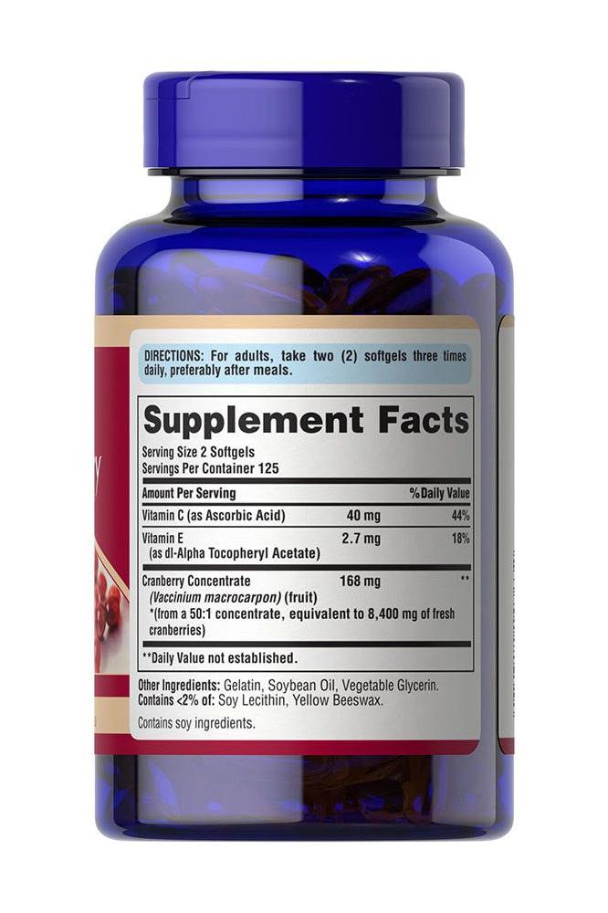 Puritan's Pride Cranberry Fruit Concentrate supplement bottle with nutrition facts label highlighting vitamin C and E.