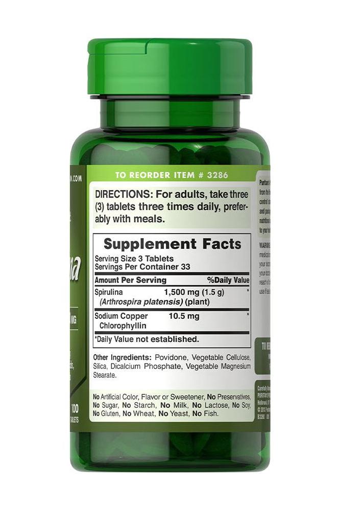 Puritan's Pride Spirulina 500 mg supplement facts label on green bottle, showing ingredients and dosage information.