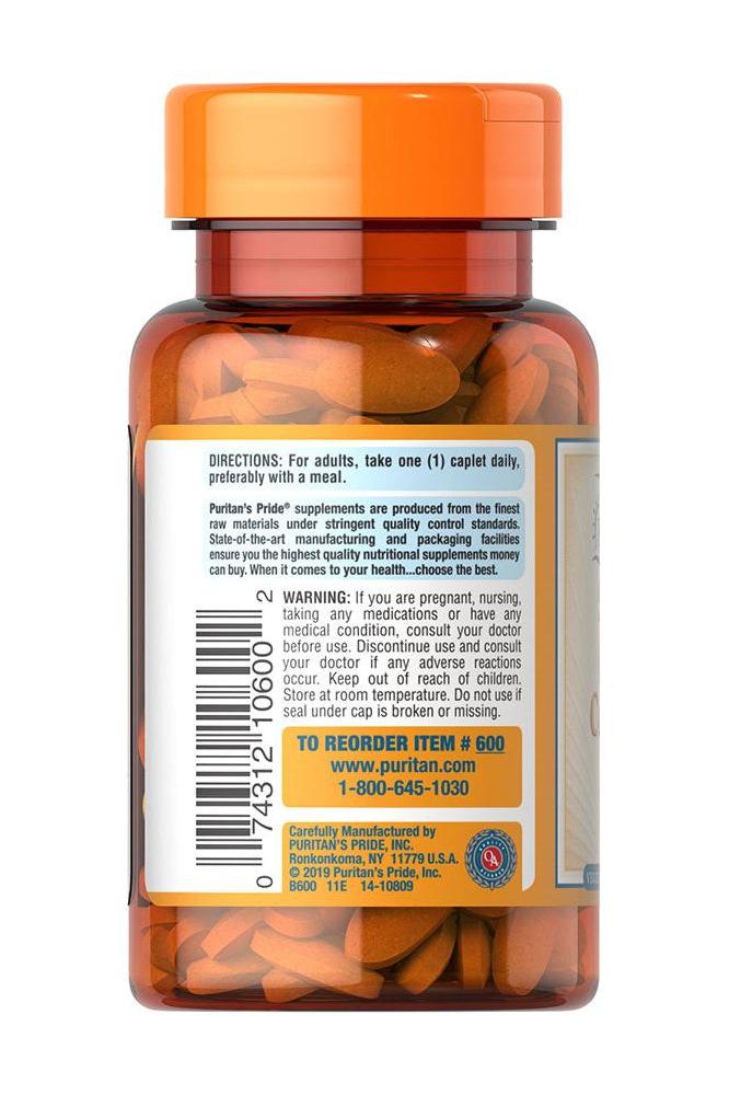 Puritan's Pride Vitamin C-500 Complex bottle with capsules and usage instructions on the label.