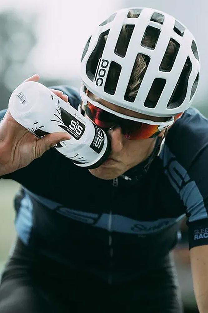 Cyclist drinking from a Science in Sport bottle, showcasing modern design and ergonomic grip.