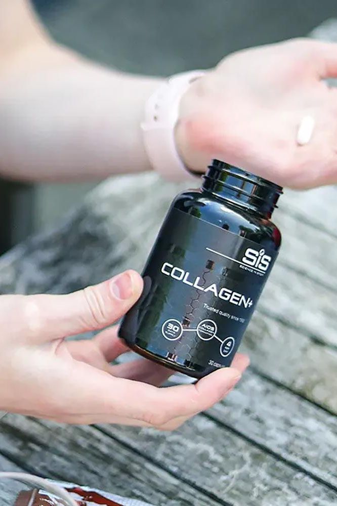 Hands holding a bottle of Science in Sport Collagen+ capsules for joint health and mobility.