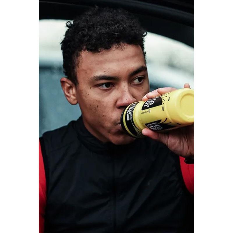 Athlete drinking Science in Sport GO Energy Powder from a yellow bottle, enhancing performance during training.