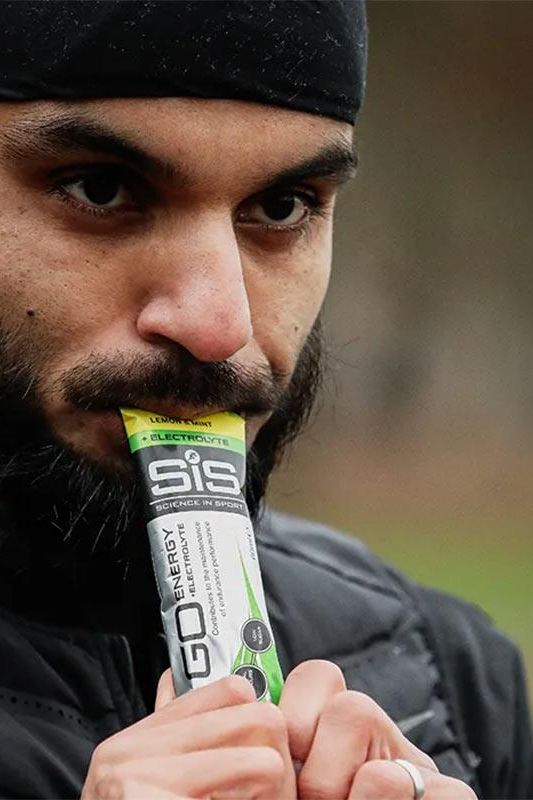 Athlete enjoying Science in Sport GO Isotonic Energy Gel for quick energy during training.
