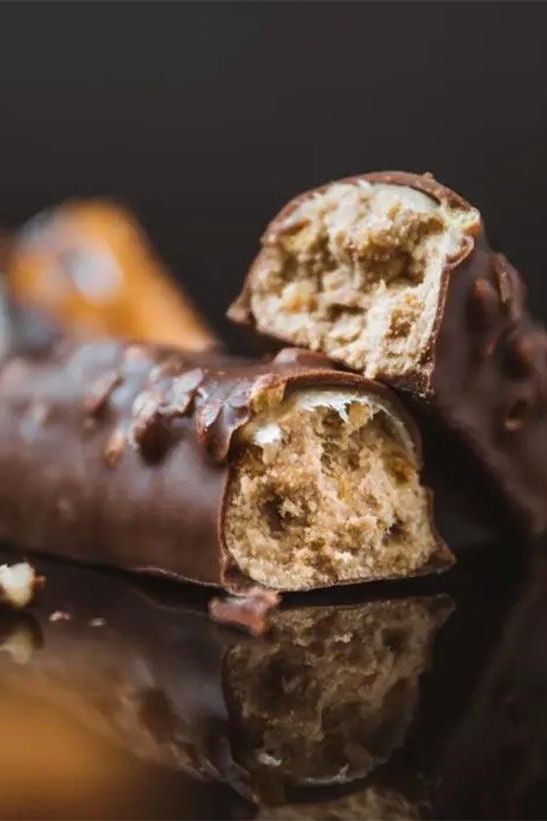 Close-up of Science in Sport Protein20 Bar, showcasing its chocolate coating and soft interior for a tasty snack.