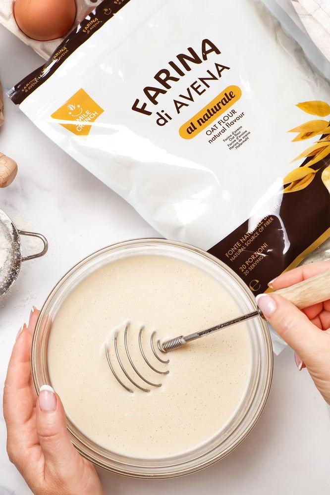 Bowl of batter being whisked with Smile Crunch oat flour bag in the background.