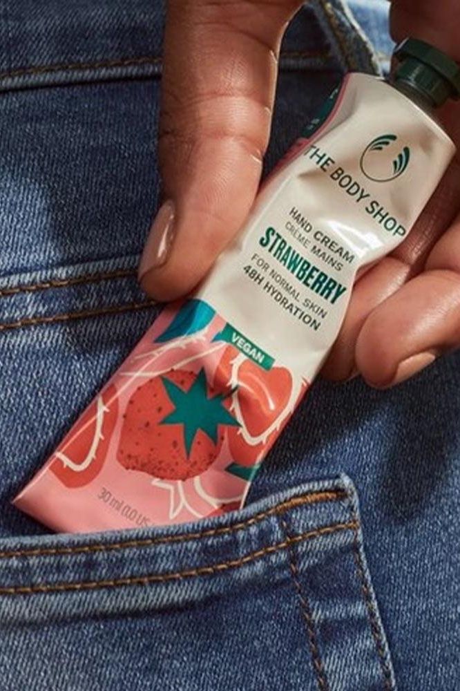 Vegan Strawberry Hand Cream by The Body Shop, 30ml, in a hand, showcasing hydration and natural ingredients.