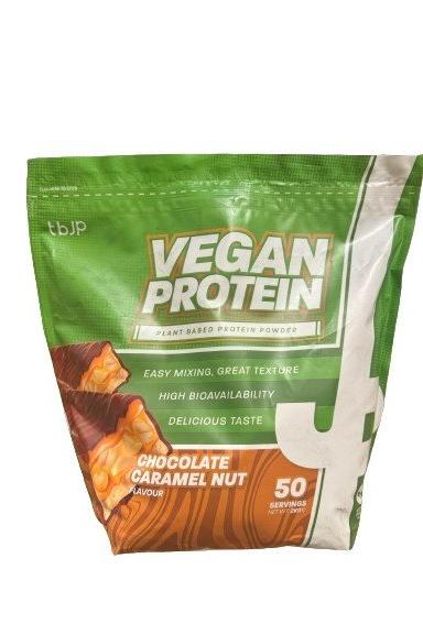 Trained by JP Vegan Protein powder in Chocolate Caramel Nut flavor, plant-based, easy mixing, 50 servings.