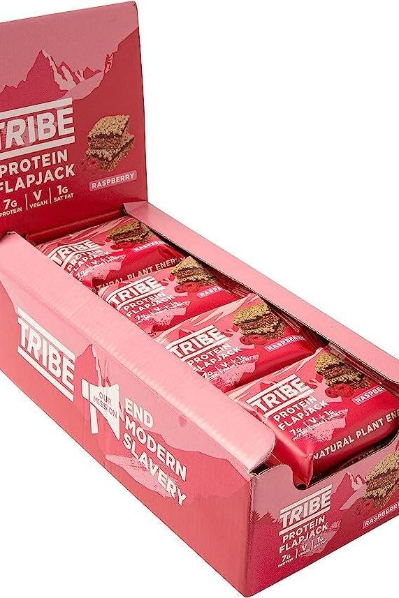 TRIBE Protein Flapjack box displaying raspberry-flavored energy bars with 7g plant protein and vegan ingredients.