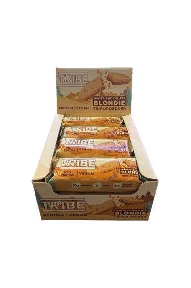 Tribe Triple Decker protein bars in a display box, featuring Vegan White Chocolate Blondie flavor.
