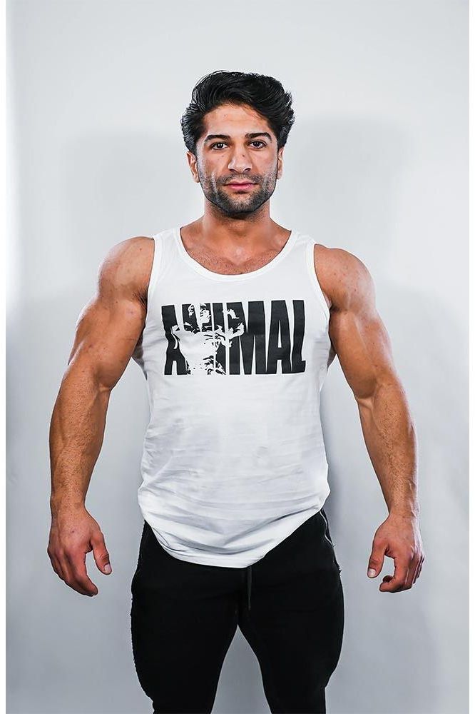 Man wearing a stylish white tank top with 'ANIMAL' print, showcasing a confident look for gym training.