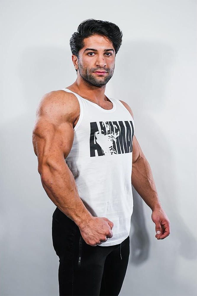 Muscular man wearing Universal Nutrition Iconic Tank Top with bold print, ideal for workouts and stylish gym outfits.