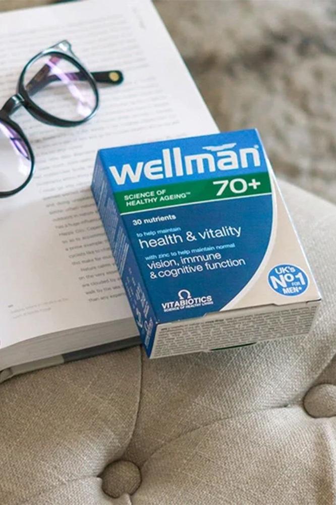 Wellman 70+ vitamins for men over 70, supporting health, vision, and cognitive function, in packaging on a table.