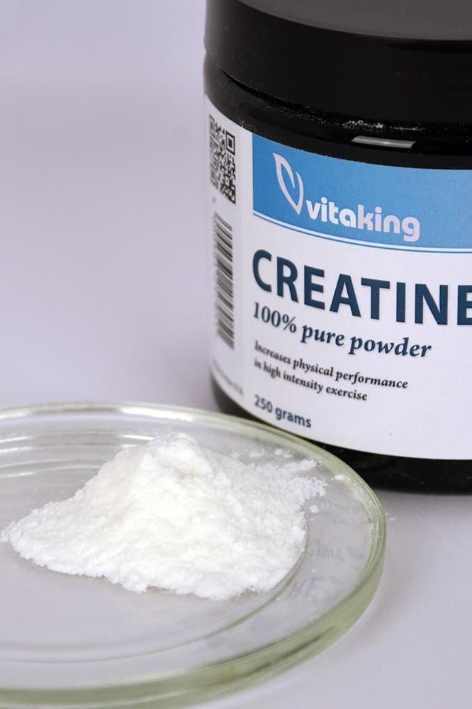Vitaking Creatine 100% Pure Powder in a jar with powder on a plate, 250g for muscle support and performance.